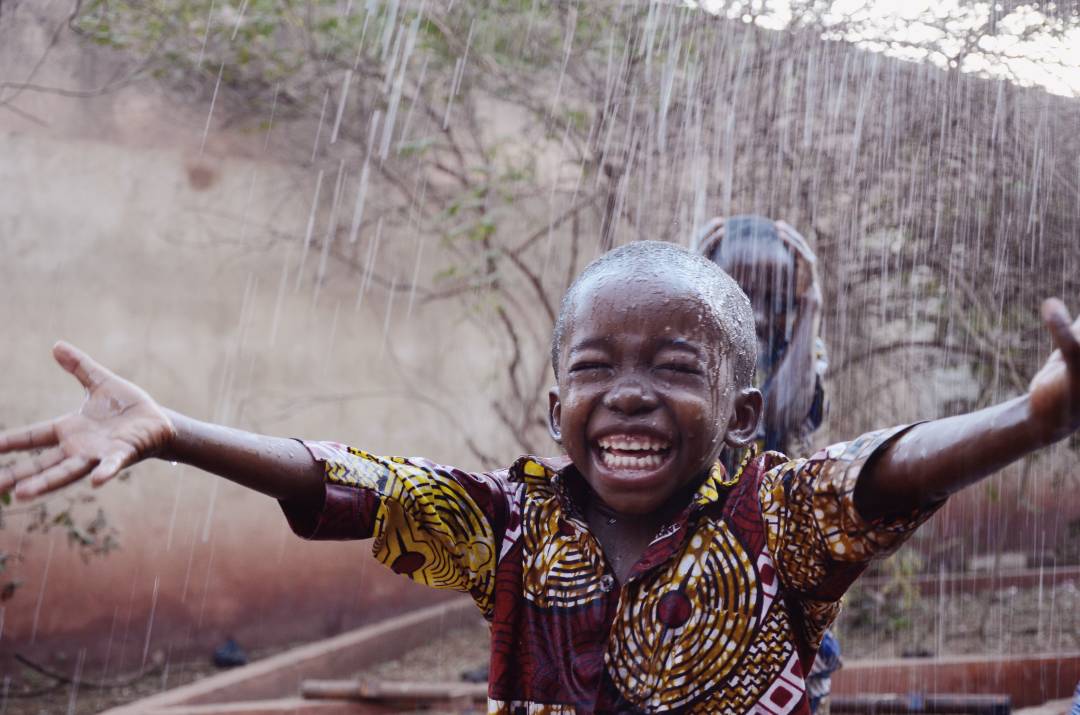 child_happy_rain_dryseason.jpg