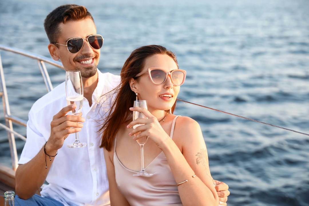 happy_young_couple_resting_on_yacht.jpg