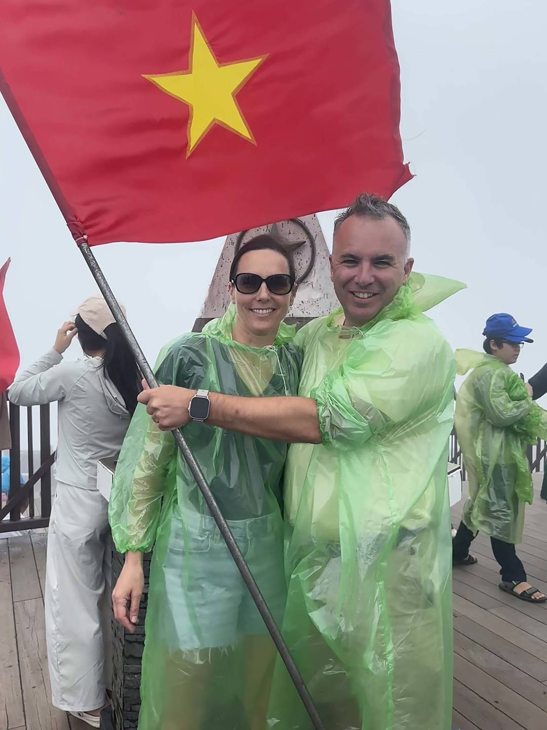 family_in_rain_with_vietnam_flag.jpg